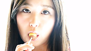 Depraved Asian Hottie Yumi Ishikawa Licks Two Lollipops